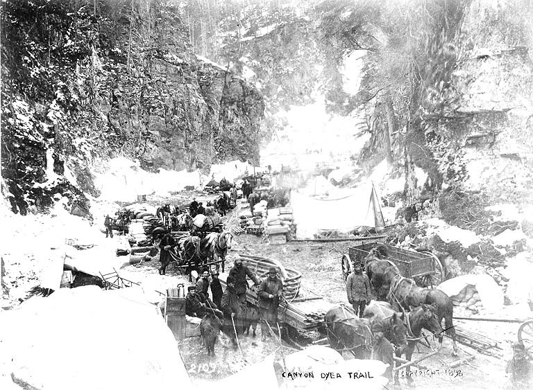 Klondikers_with_horse_drawn_wagons_and_sled_at_Canyon,_Chilkoot_Trail,_Alaska,_1898_(HEGG_187)